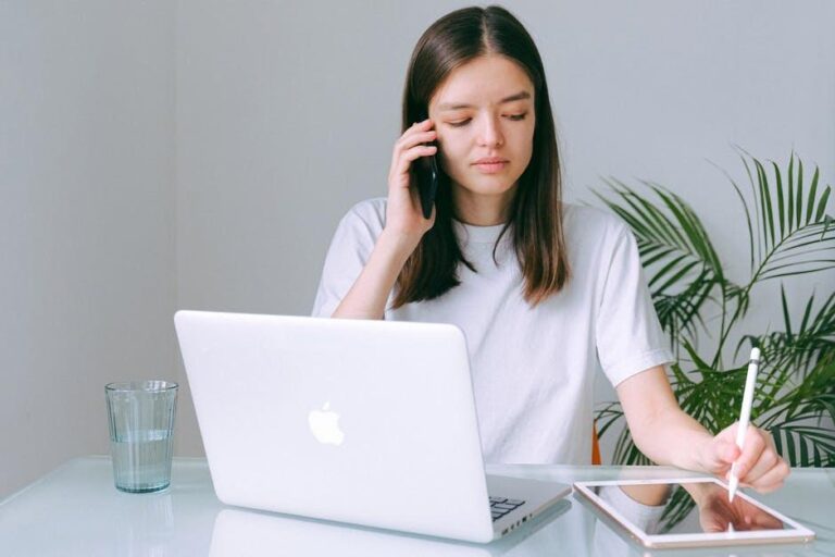 Woman on phone taking notes